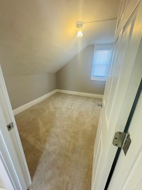 bonus room with vaulted ceiling, baseboards, and carpet floors