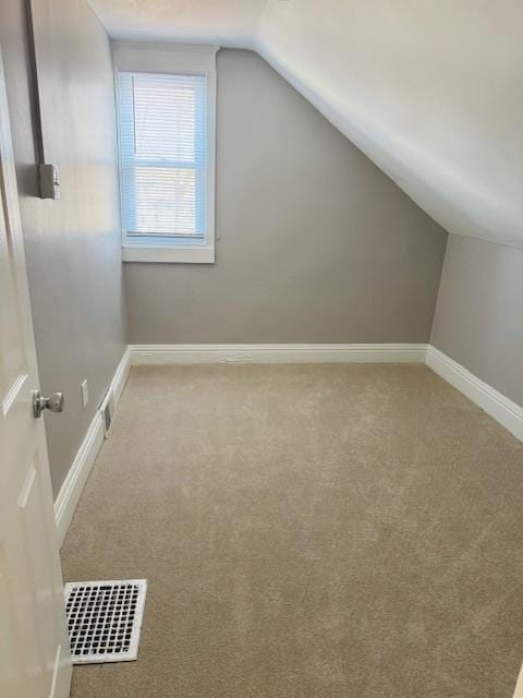 bonus room featuring vaulted ceiling, carpet, visible vents, and baseboards