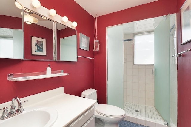 full bathroom with vanity, toilet, and a shower stall