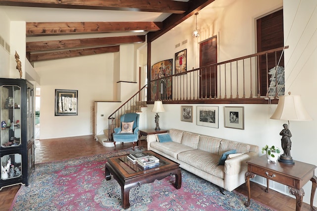 living room featuring stairs, beam ceiling, visible vents, and high vaulted ceiling