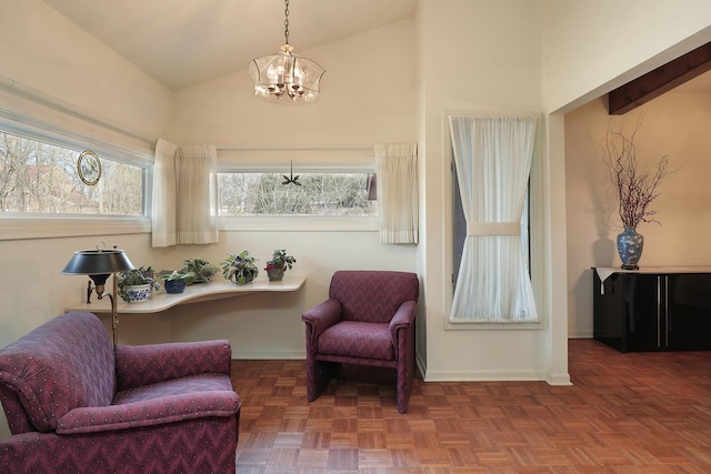 sitting room featuring baseboards, plenty of natural light, and a chandelier