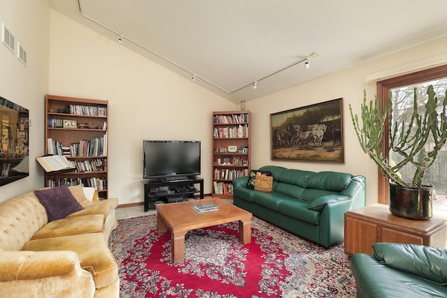 living area with visible vents, track lighting, and vaulted ceiling