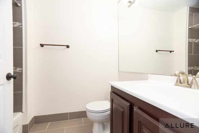 bathroom featuring vanity, tile patterned floors, toilet, and walk in shower