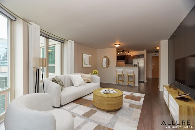 living room featuring dark wood-type flooring and baseboards