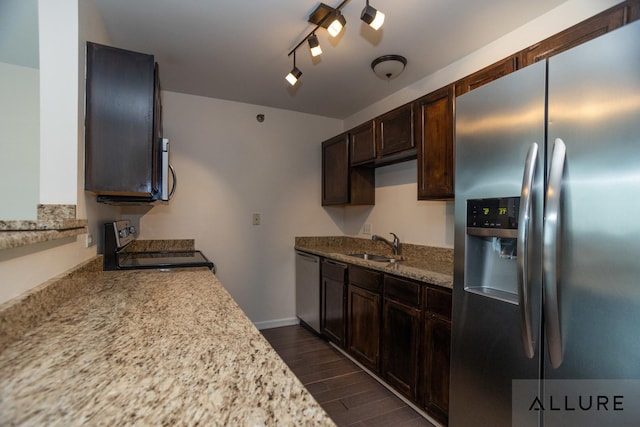 kitchen featuring a sink, stainless steel appliances, dark wood-type flooring, dark brown cabinets, and rail lighting