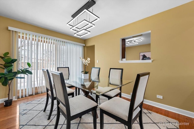 dining room with baseboards and wood finished floors