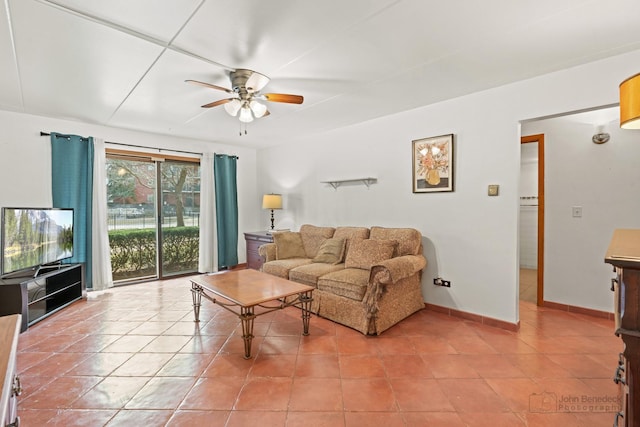 living room with baseboards, light tile patterned flooring, and a ceiling fan