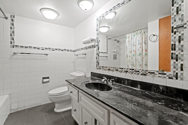 full bath with tile patterned floors, a shower with curtain, toilet, tile walls, and vanity