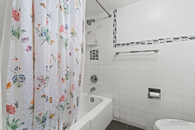 bathroom featuring shower / tub combo with curtain, tile walls, tile patterned flooring, and toilet