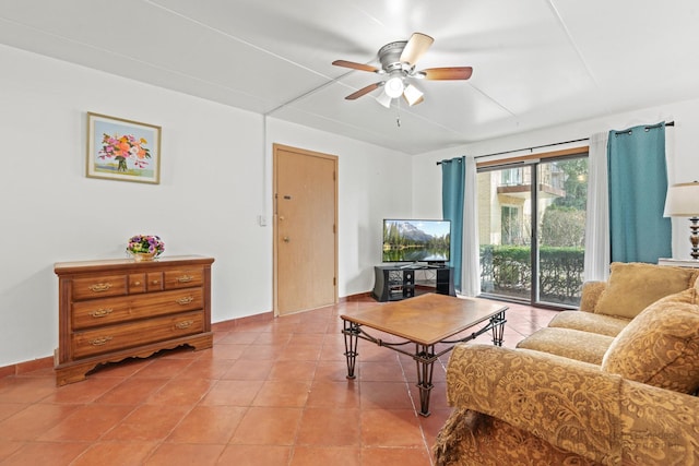 living room featuring light tile patterned floors, baseboards, and a ceiling fan