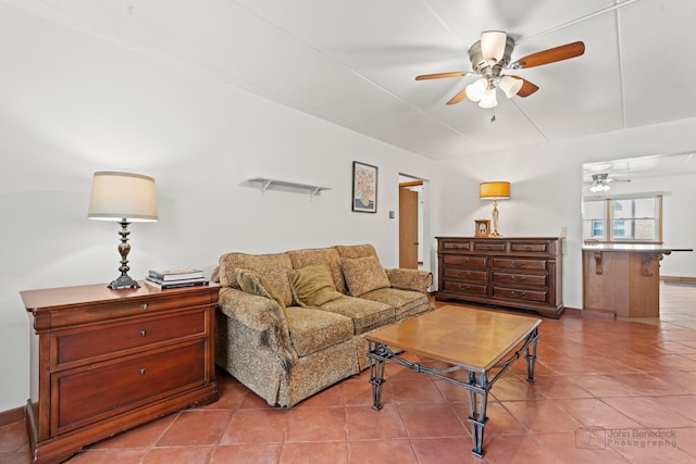 tiled living room featuring baseboards and a ceiling fan