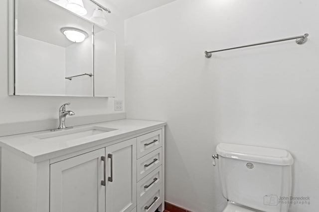 bathroom with toilet and vanity