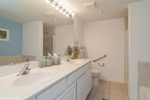 bathroom with tile patterned flooring, toilet, a shower, and a sink