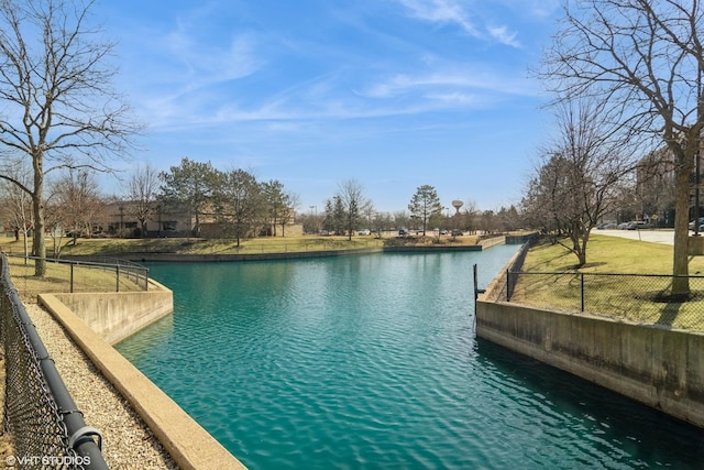 view of pool with fence and a water view