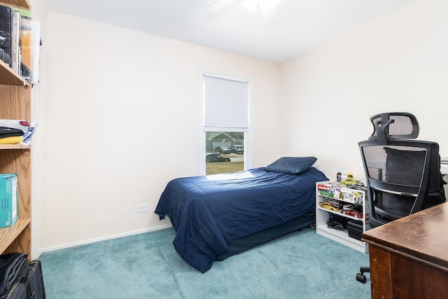 bedroom with a ceiling fan, baseboards, and carpet floors