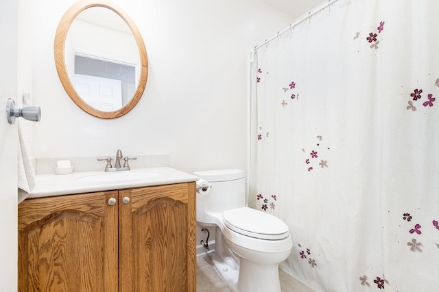 bathroom with vanity, toilet, and tile patterned flooring