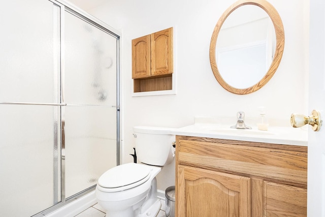 bathroom with vanity, toilet, and a shower stall