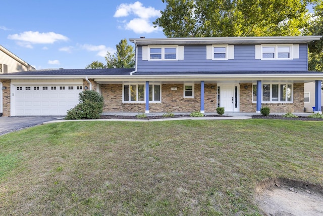 traditional-style house featuring a porch, a front lawn, a garage, aphalt driveway, and brick siding