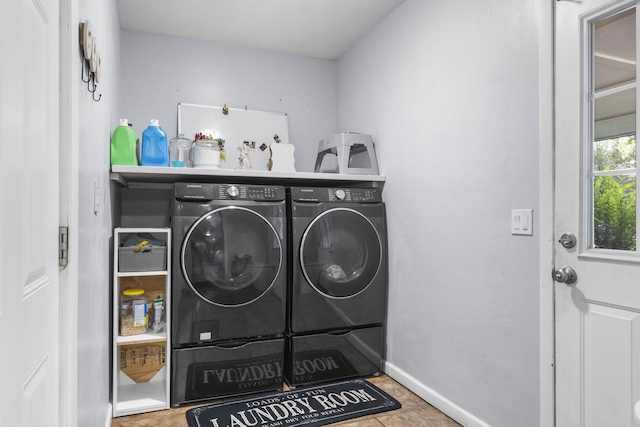 laundry room featuring laundry area, separate washer and dryer, and baseboards