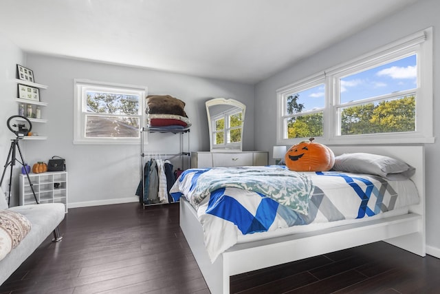 bedroom with wood finished floors and baseboards