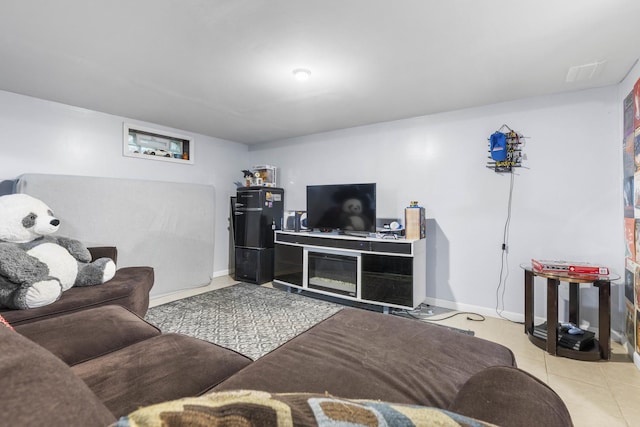 living room featuring light tile patterned floors and baseboards