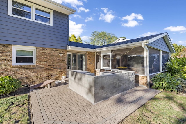 view of patio with a sunroom