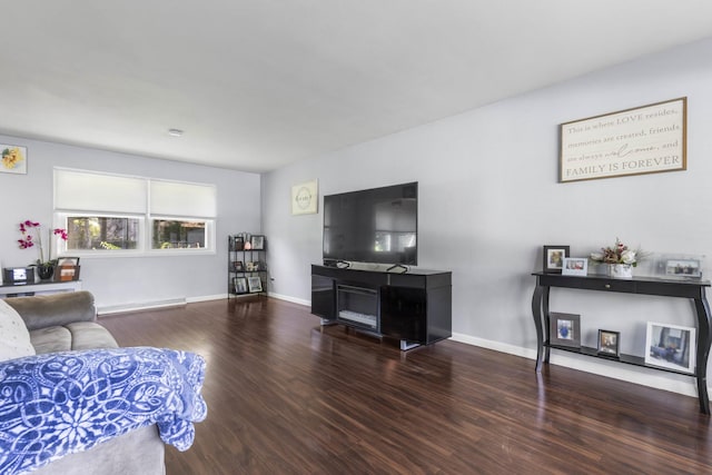 living room featuring baseboards and wood finished floors