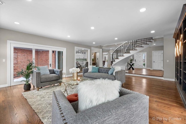 living area with stairway, recessed lighting, baseboards, and wood finished floors