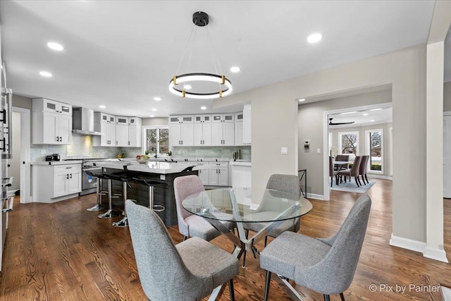 dining area featuring dark wood-type flooring, recessed lighting, and baseboards