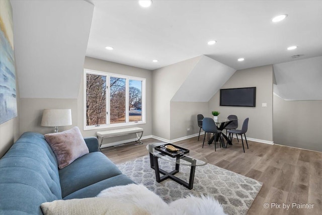 living room featuring recessed lighting, baseboards, lofted ceiling, and wood finished floors