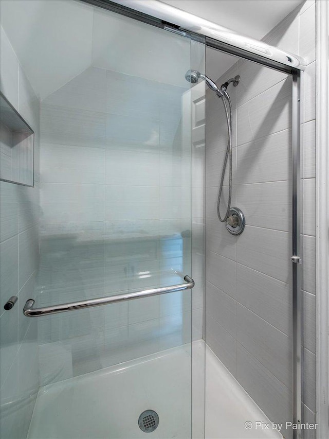 full bath featuring a shower stall