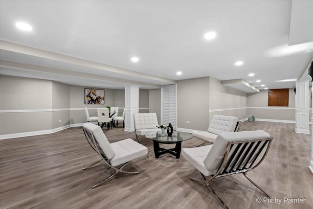 living room featuring recessed lighting, baseboards, and wood finished floors