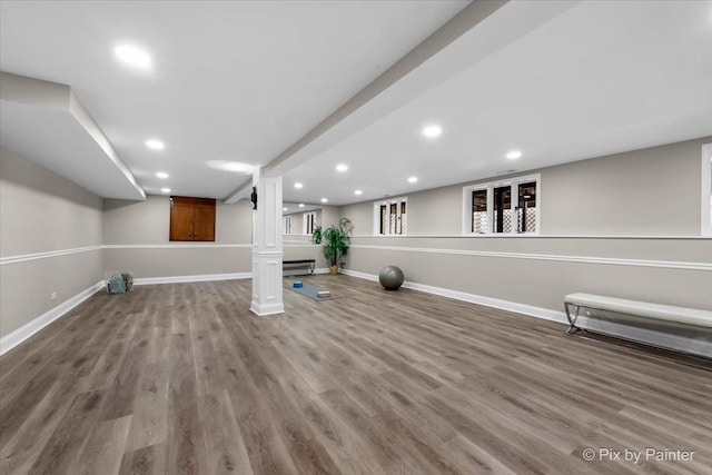 workout area featuring recessed lighting, wood finished floors, baseboards, and baseboard heating