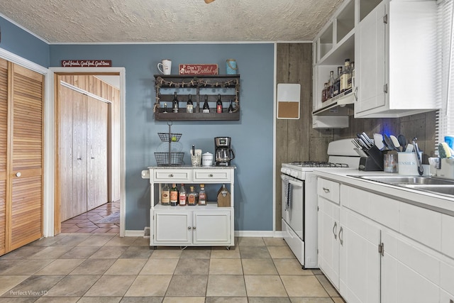 kitchen with open shelves, white cabinets, white gas range oven, and light tile patterned floors