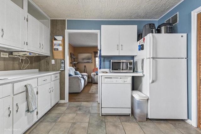 kitchen featuring white cabinets, white appliances, and light countertops