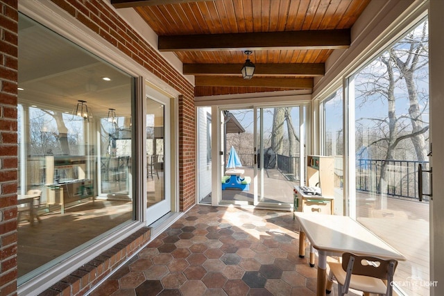 sunroom featuring beamed ceiling and wood ceiling