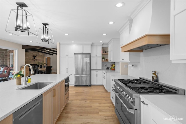 kitchen featuring a sink, custom exhaust hood, appliances with stainless steel finishes, and light countertops