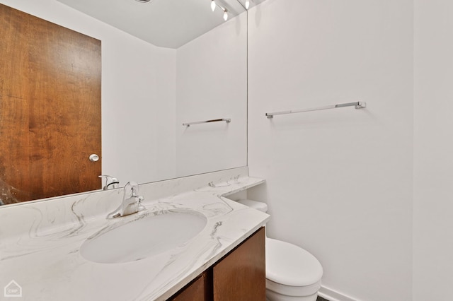 bathroom with toilet and vanity