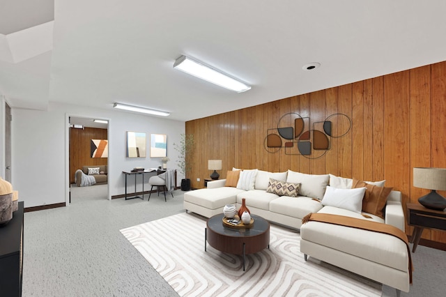 living room featuring baseboards and wood walls