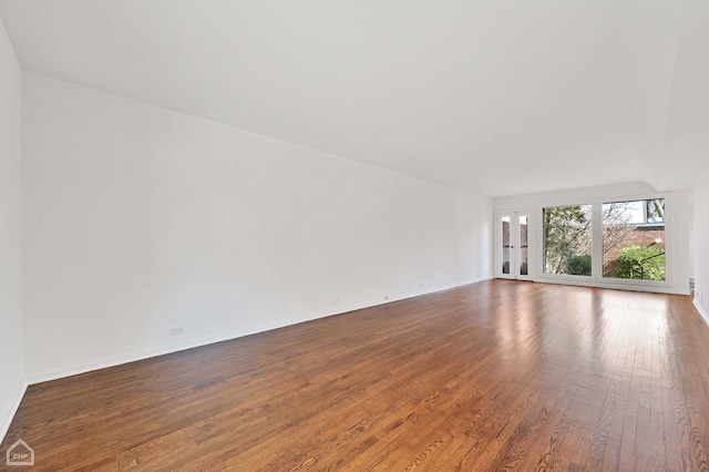 unfurnished room featuring baseboards and hardwood / wood-style flooring