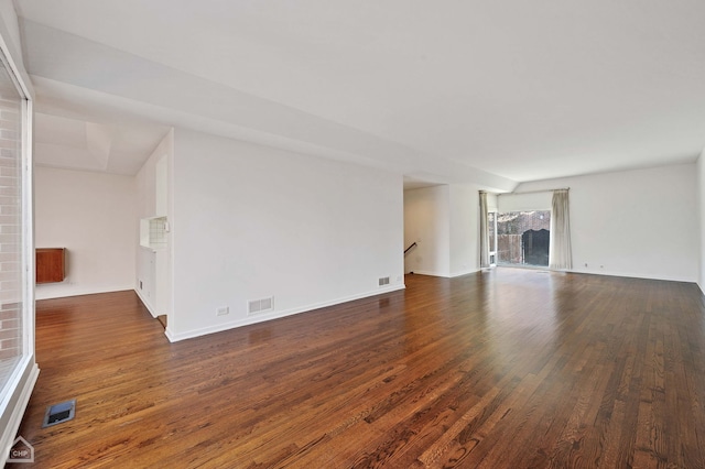 unfurnished living room featuring visible vents and wood finished floors