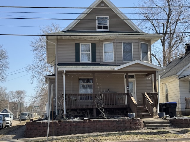 american foursquare style home with a porch