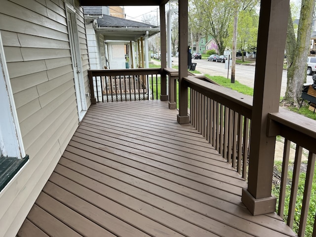 wooden deck with a residential view and a porch