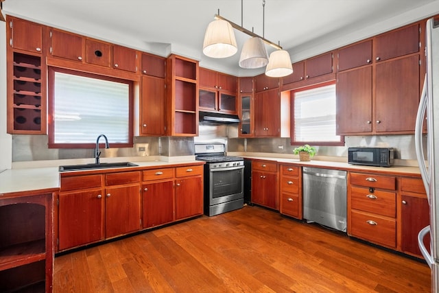 kitchen featuring a sink, light countertops, appliances with stainless steel finishes, dark wood-style floors, and open shelves