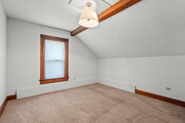 bonus room featuring lofted ceiling with beams, carpet flooring, and baseboards