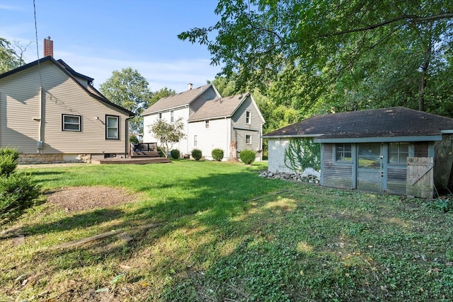 view of yard featuring an outdoor structure and a wooden deck