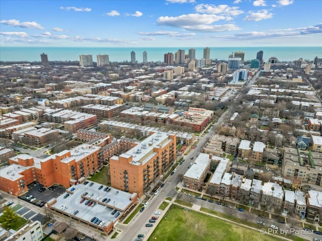 birds eye view of property featuring a water view and a city view