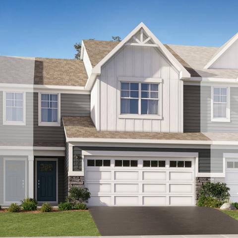 view of front of house with a front yard, an attached garage, board and batten siding, and driveway