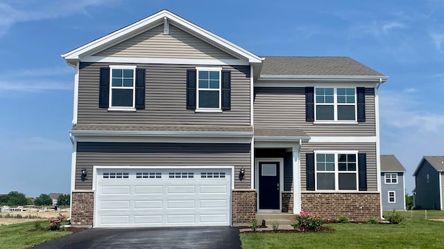 craftsman inspired home with aphalt driveway, brick siding, a garage, and a front yard