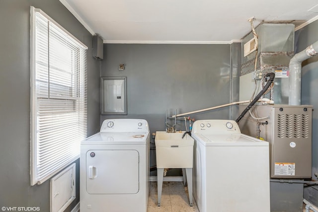 washroom with laundry area, electric panel, separate washer and dryer, and a sink